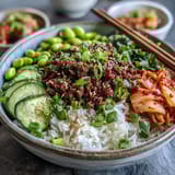Vibrant Korean Ground Beef Bowl with edamame, cucumber, carrot, and kimchi for a quick, satisfying weeknight meal.  