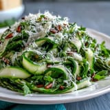 Shaved asparagus ribbons tossed with lemon and Parmesan in a bright Mediterranean salad.