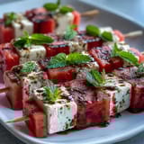 Colorful watermelon feta mint skewers arranged on a platter, perfect for refreshing summer parties and appetizers.