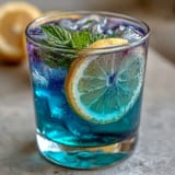 Vibrant butterfly pea flower lemonade photo, a visually stunning and refreshing summer drink.