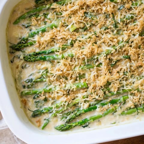 Asparagus Casserole featuring tender green spears baked in rich cream sauce, finished with melted cheese and crisp breadcrumbs for a comforting bite.