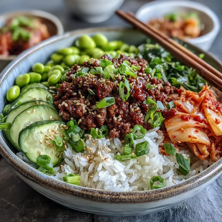 Vibrant Korean Ground Beef Bowl with edamame, cucumber, carrot, and kimchi for a quick, satisfying weeknight meal.  