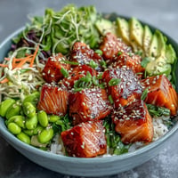 Vibrant salmon poke bowl with creamy avocado and edamame.